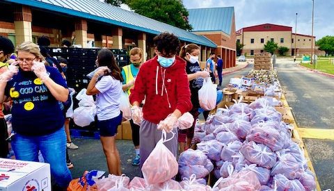 Volunteers assist at the San Antonio Food Bank food distribution at Southside ISD.