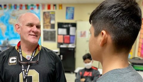 Losoya Middle School award-winning teacher Mr. Lucian Bogran visits with one of his students.