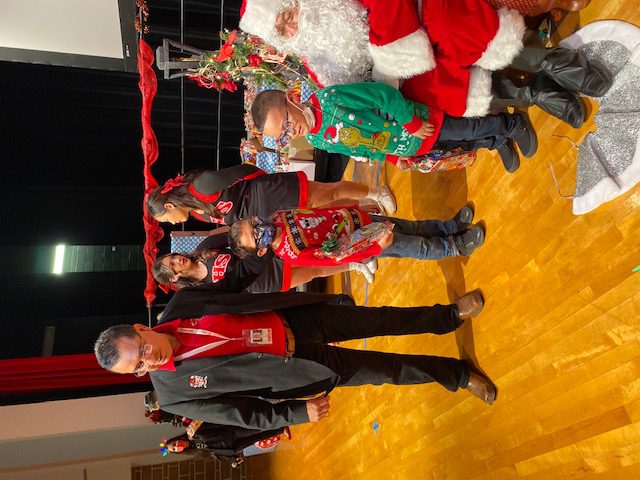 Superintendent Mr. Rolando Ramirez ushers students to see Santa Claus at the Southside High School auditorium. 