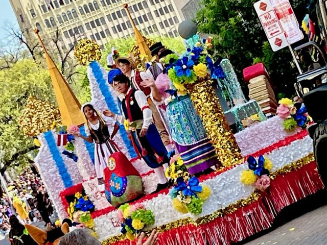 Southside High School academic super stars ride on the Expressions of Eastern Europe (Ukraine) float in the Battle of Flowers Parade on April 8, 2022. 